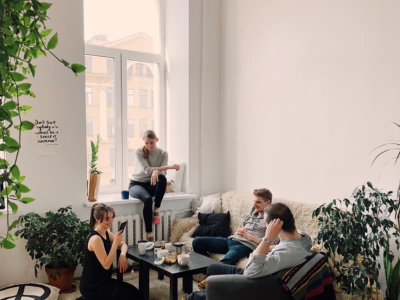 Friends talking together in a bright living room