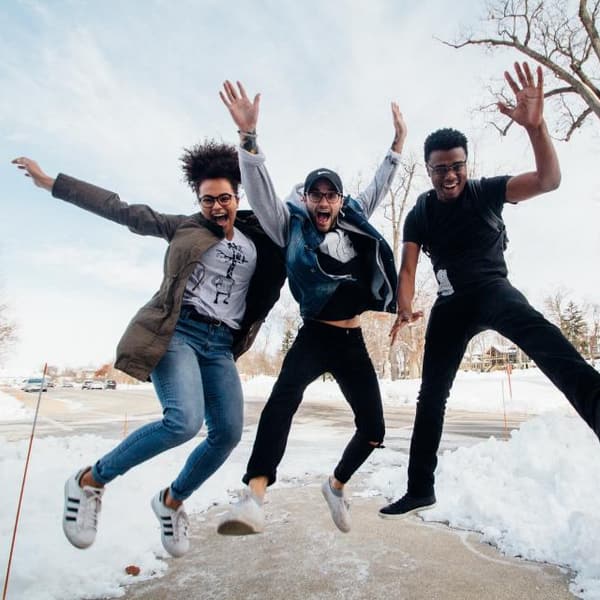 Friends jumping for joy outdoors